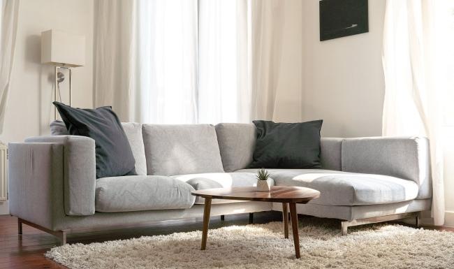 Wide open living areas flooded with natural light oversized windows brighten spacious, furnished living room
